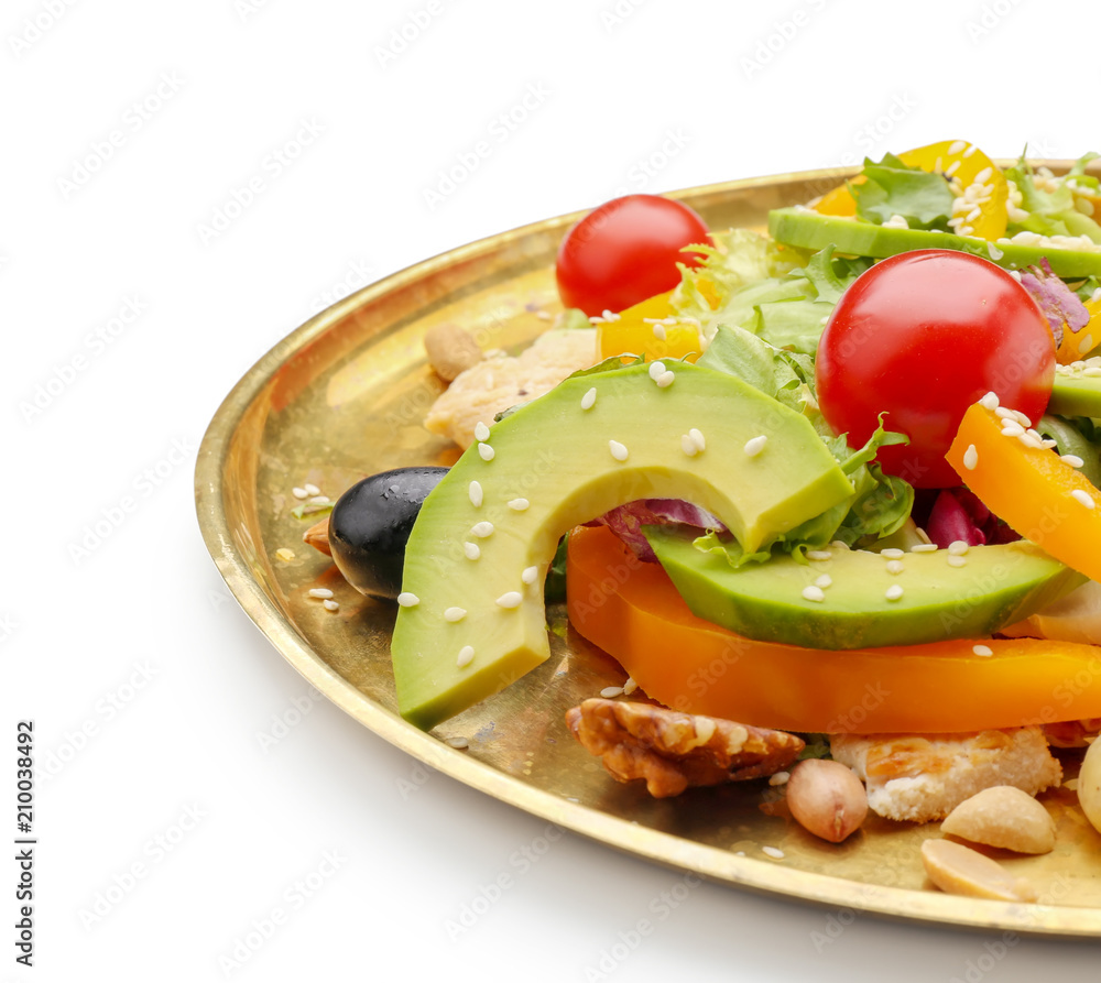 Plate of tasty salad with ripe avocado on white background, closeup