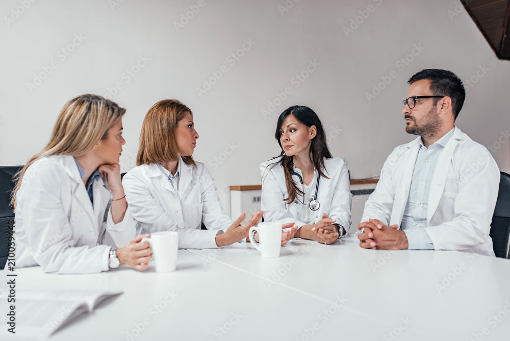 Hospital staff meeting in conference room.