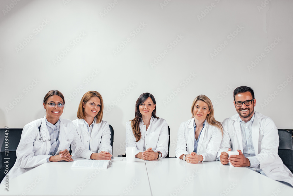 Successful team of medical doctors are looking at camera. Copy space.