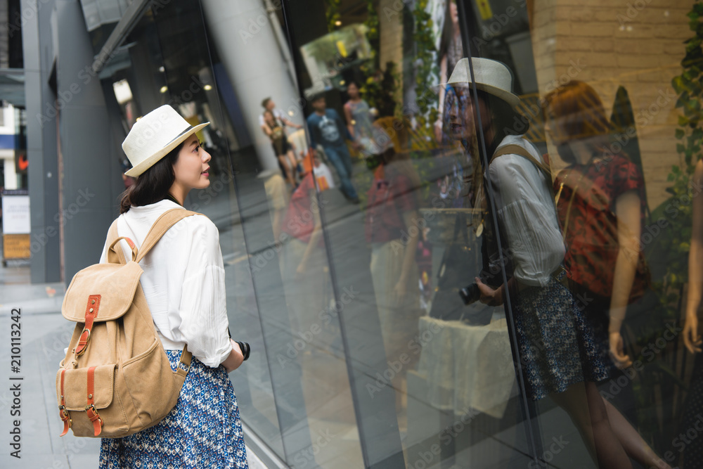 joyful woman shopping with backpack