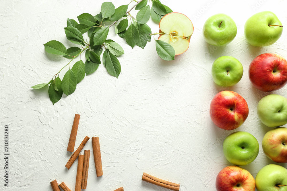 Frame made of apples and cinnamon on white background