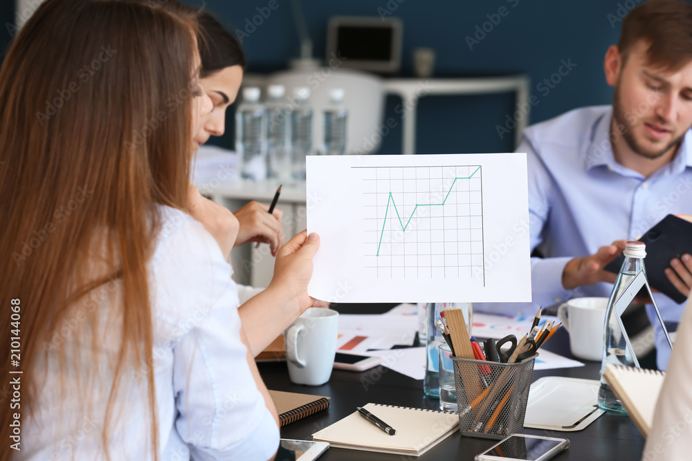 Young woman with document during business meeting