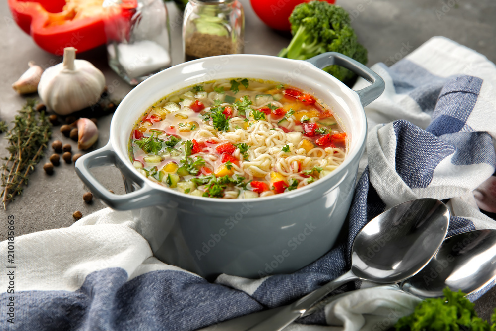 Fresh vegetable soup with noodles in dish on table. Diet food