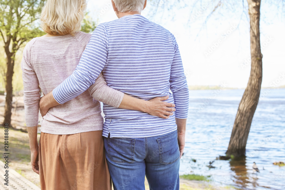 Mature couple resting in park on spring day