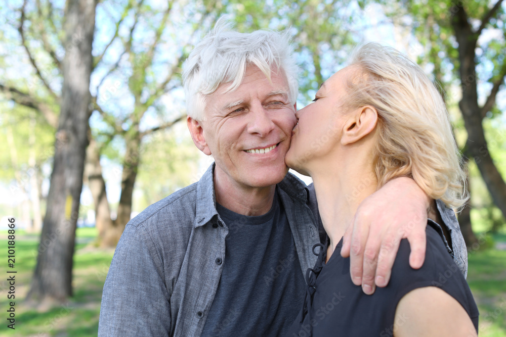 Mature couple resting in park on spring day