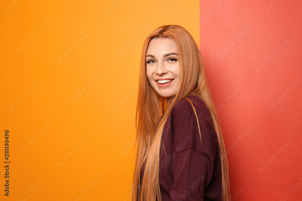 Beautiful young woman on color background