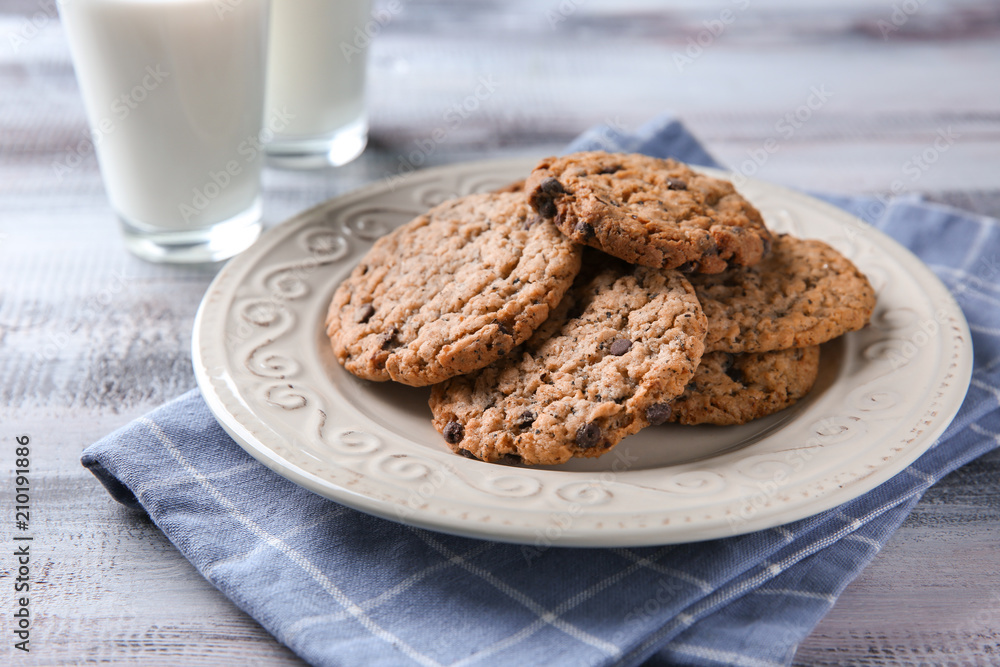 Plate with delicious oatmeal cookies on table