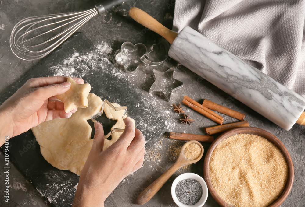 Woman preparing cookies on table