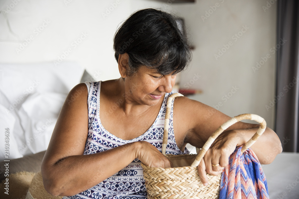 Mature woman unpacking her clothes