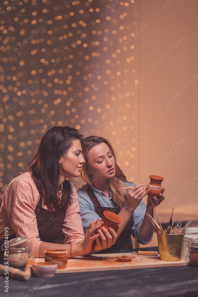 Attractive young girls in pottery