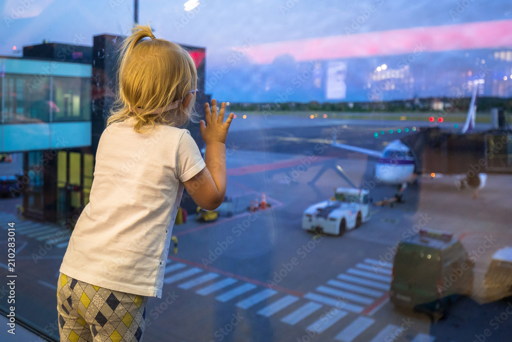 Little baby girl waiting for boarding on the airport