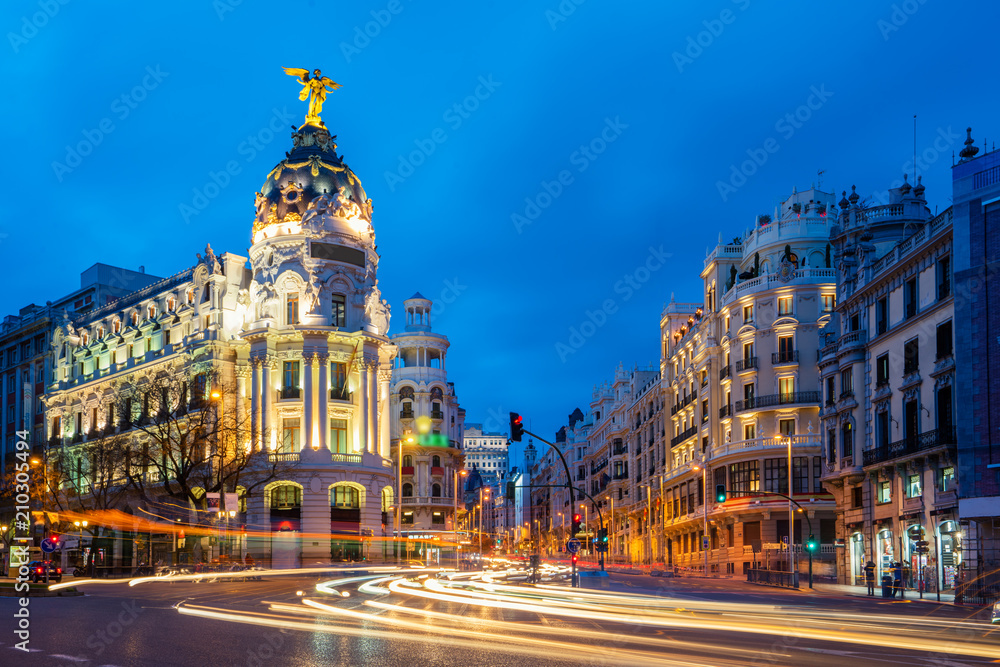 Car and traffic lights on Gran via street, main shopping street in Madrid at night. Spain, Europe. L