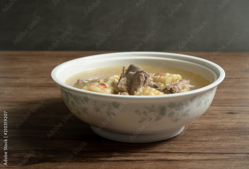 Bone soup with wood grain background