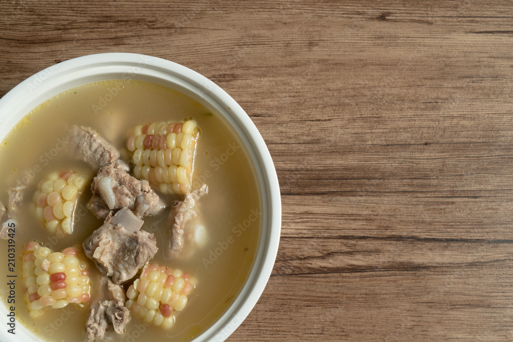 Bone soup with wood grain background