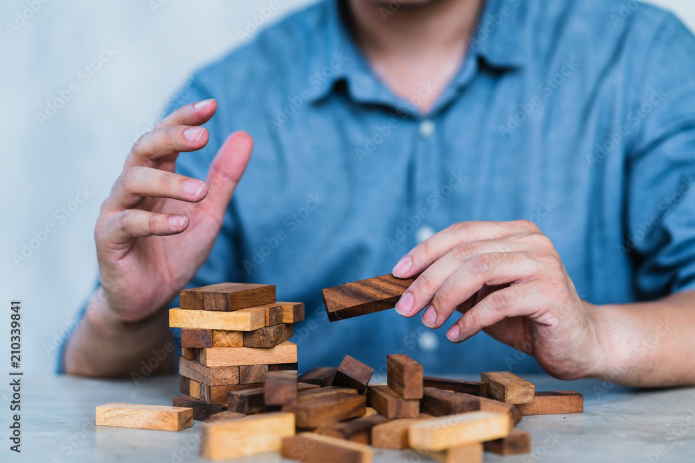 hand pull important color block from balance wooden stack business strategy and risk management cont