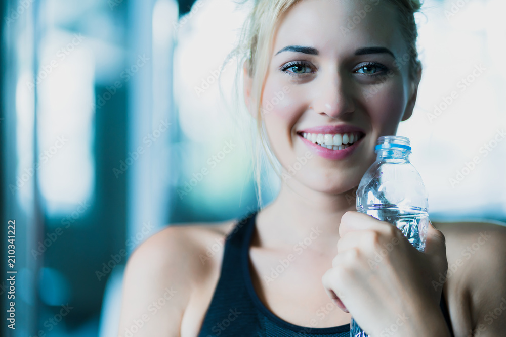 attractive caucasian woman relax with pure water after workout with happiness and joyful in gym heal