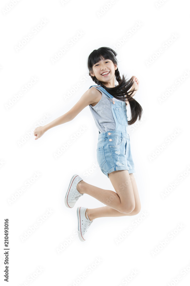 Portrait of Happy Asian child girl jumping and smiling isolated on white background