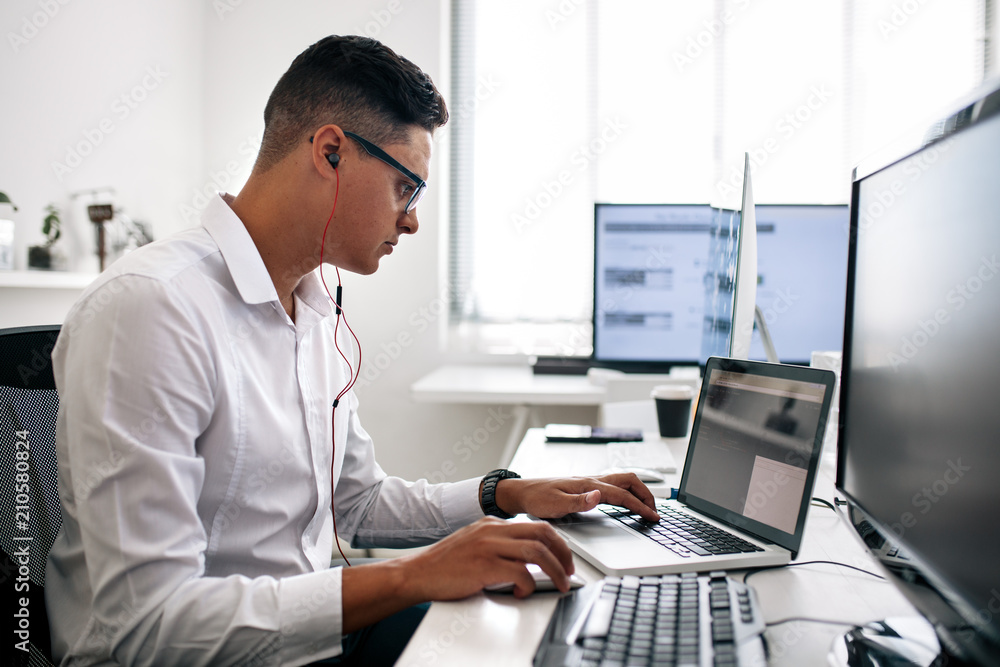 Application developer working on computer in office