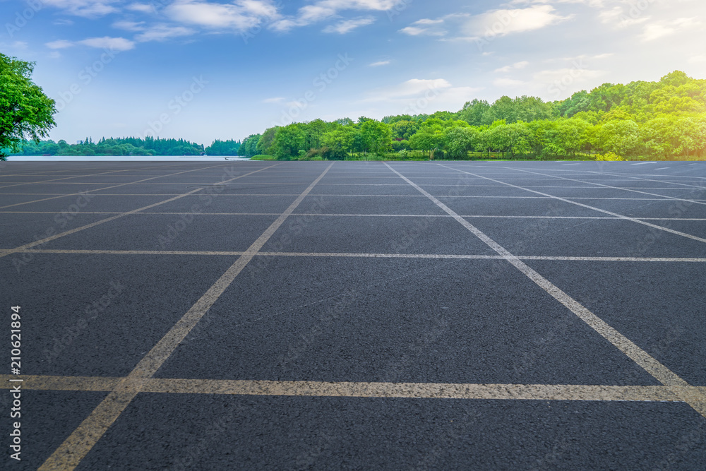 The empty asphalt road and natural landscape under the blue sky