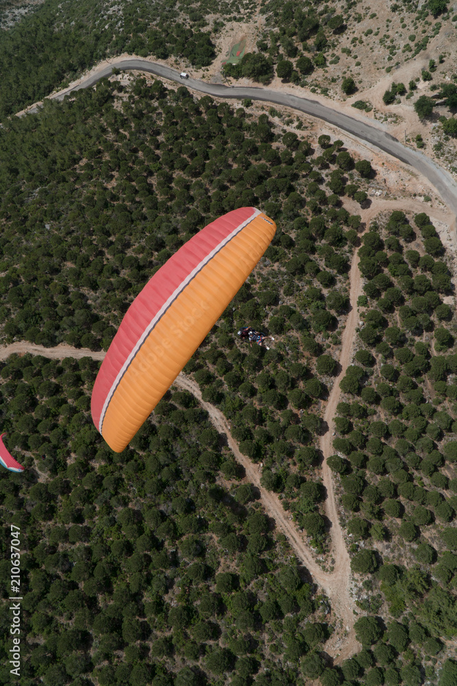 Paragliding flight over the mountain road in Turkey