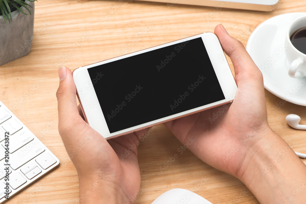 Businessman using laptop notebook and mobile phone in office