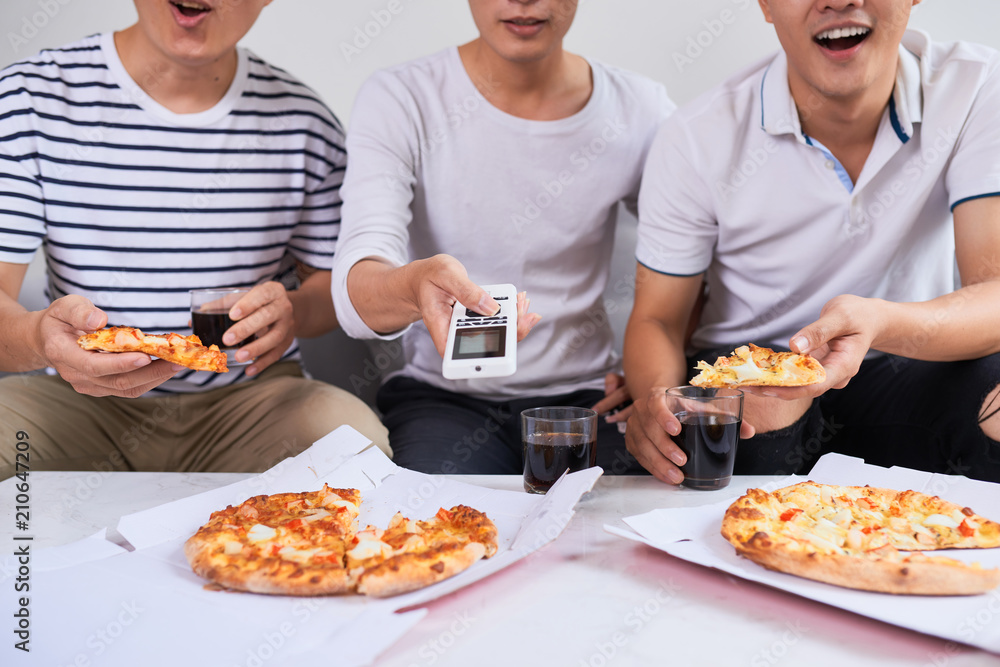 Positive joyful friends enjoying their pizza