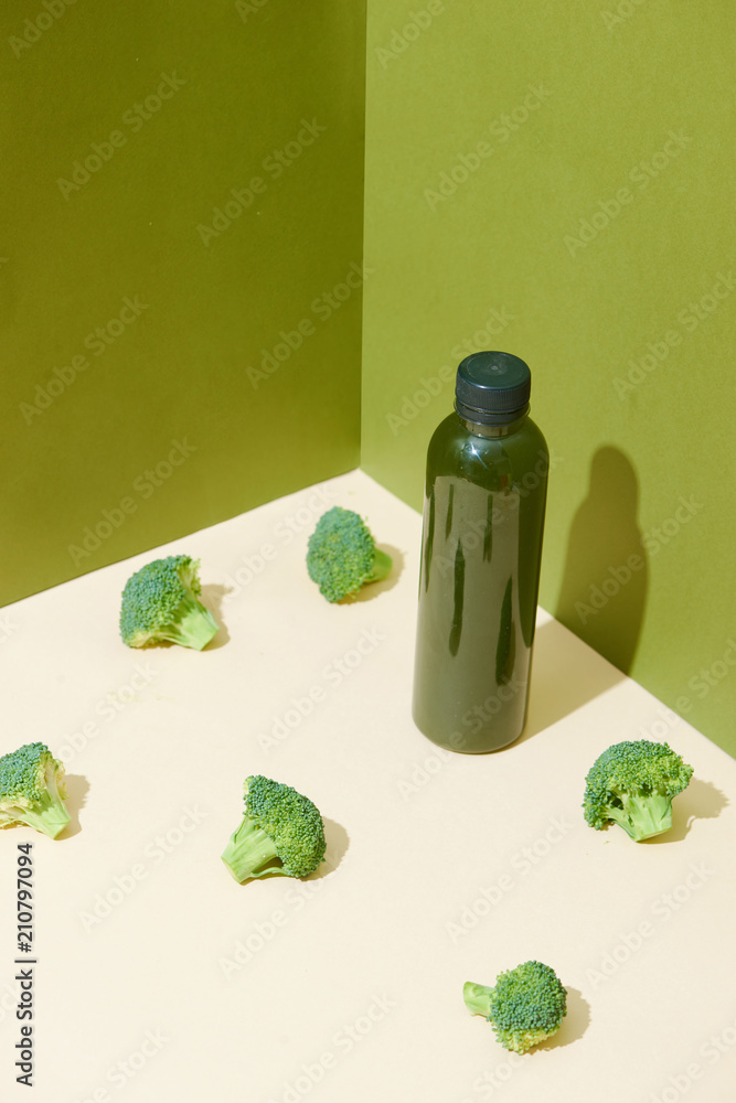 Bottle of the fresh broccoli juice on table. Healthy drink.