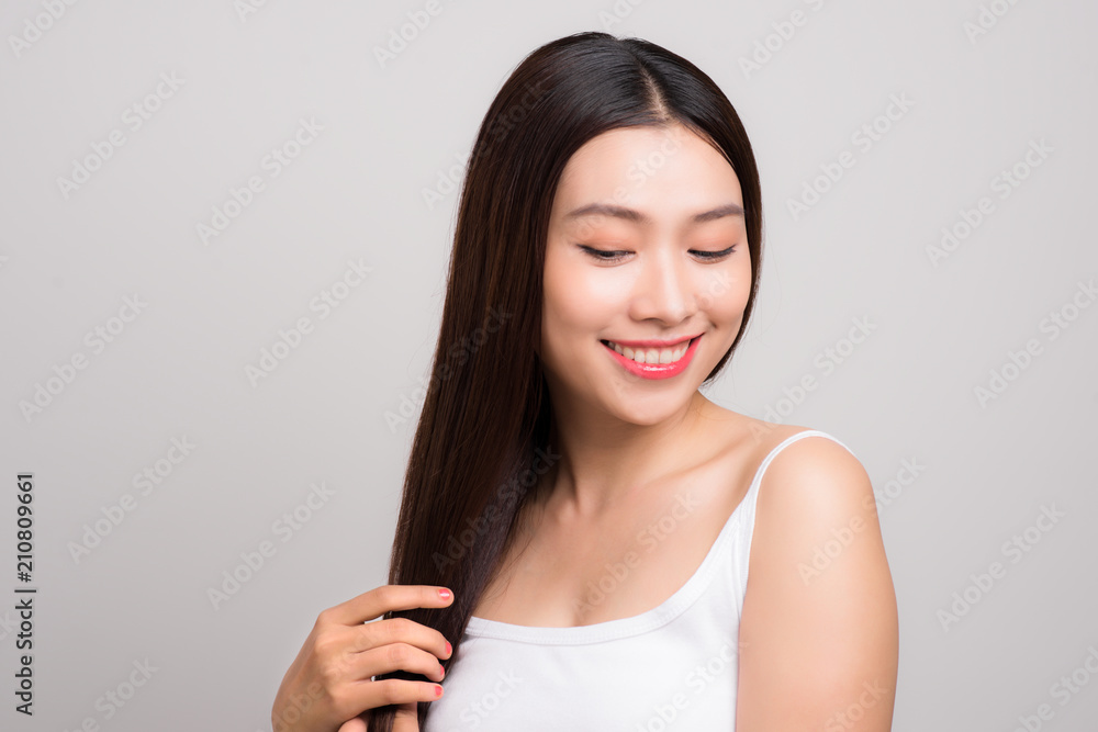 Beautiful Woman touch her health long straight hair care with smile face, asian beauty model