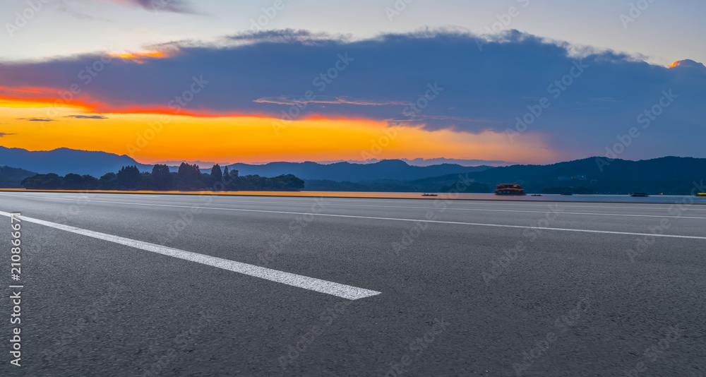 Asphalt road square and river hill under the blue sky