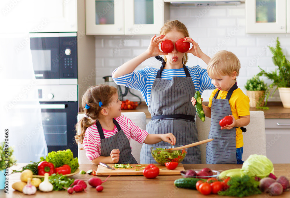 mother with children preparing vegetable salad