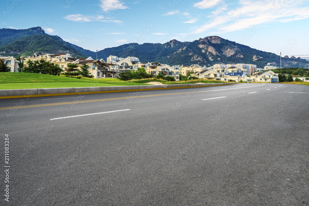 Asphalt road square and river hill under the blue sky