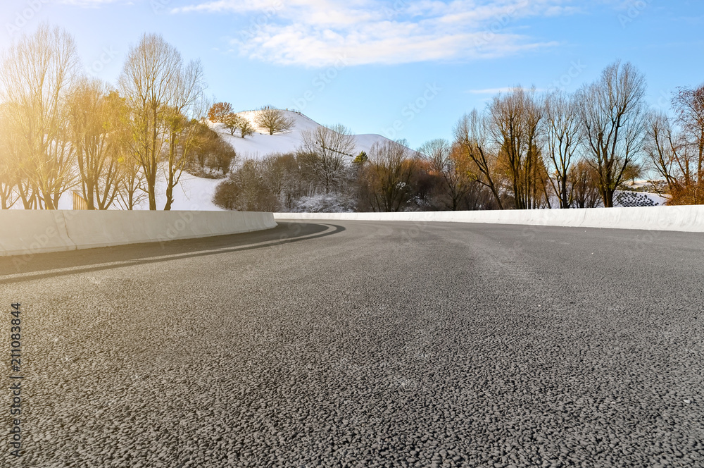 Asphalt road square and river hill under the blue sky