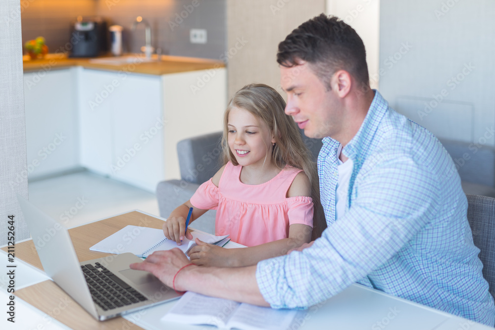 Young father with a daughter at home