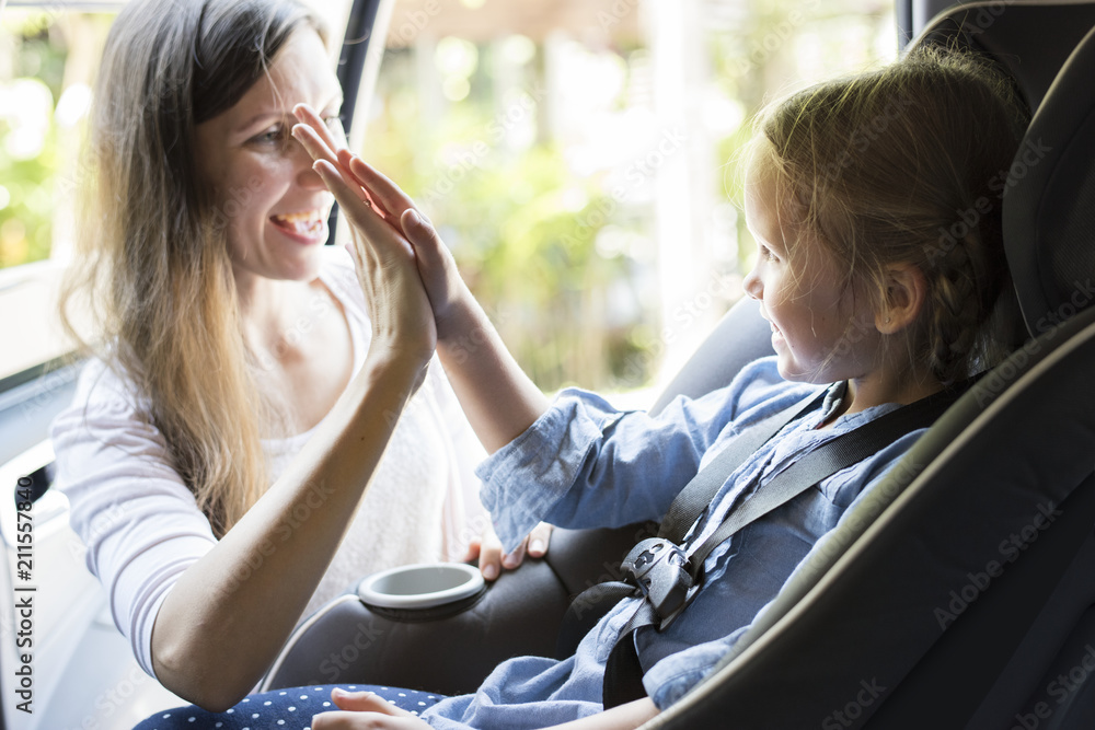 Mother helping to put on the seat belt