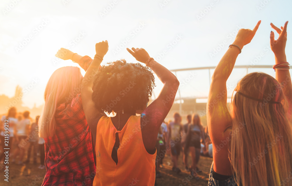 Multiethnic friends celebrating summer holi festival