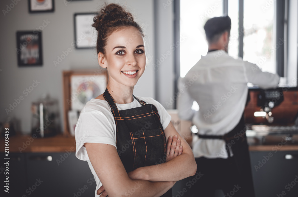 Smiling woman barista in apron, Coffee business owner