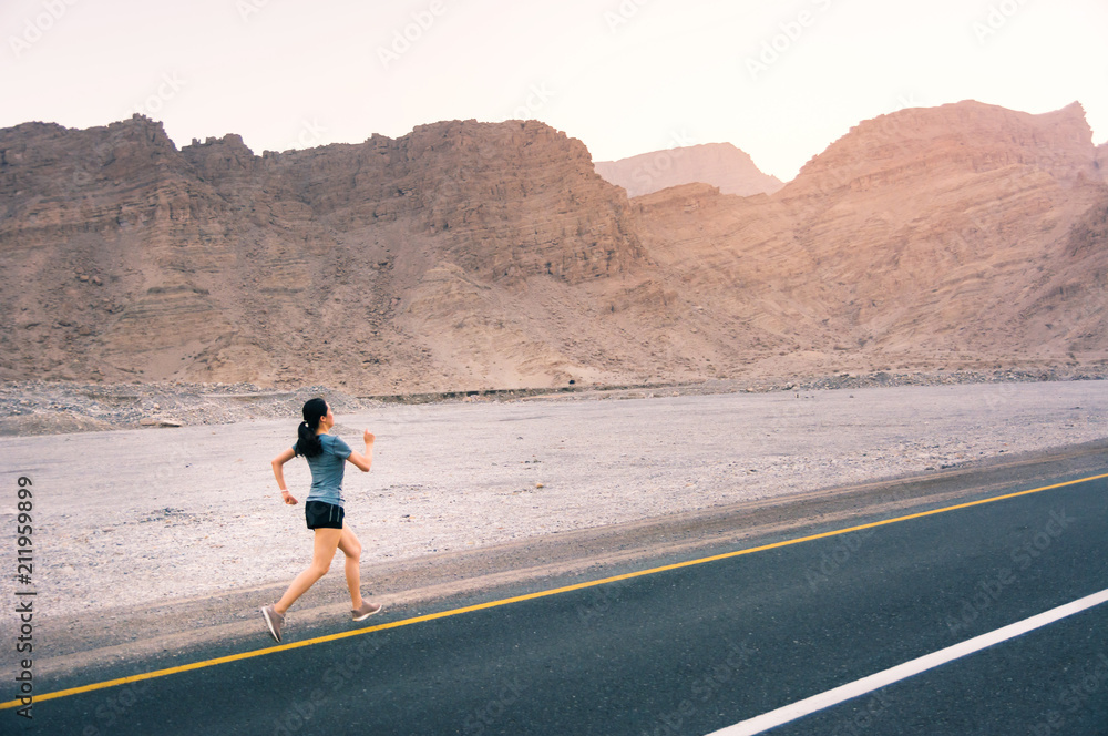 Girl running on the desert road