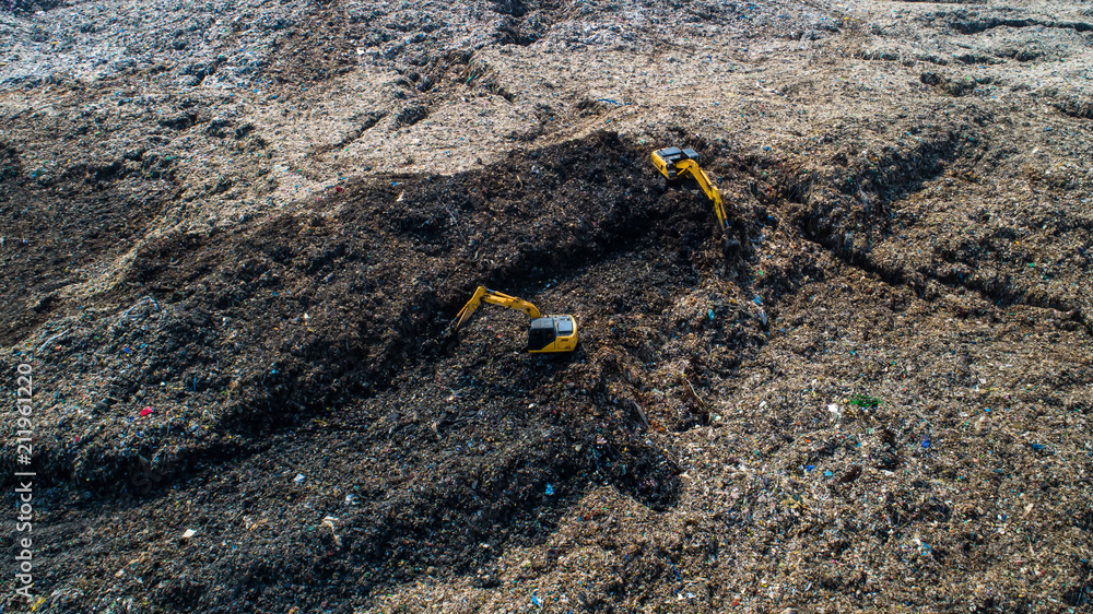 A lot of waste is disposed of in the waste disposal pits. Loaders is working on a mountain garbage. 