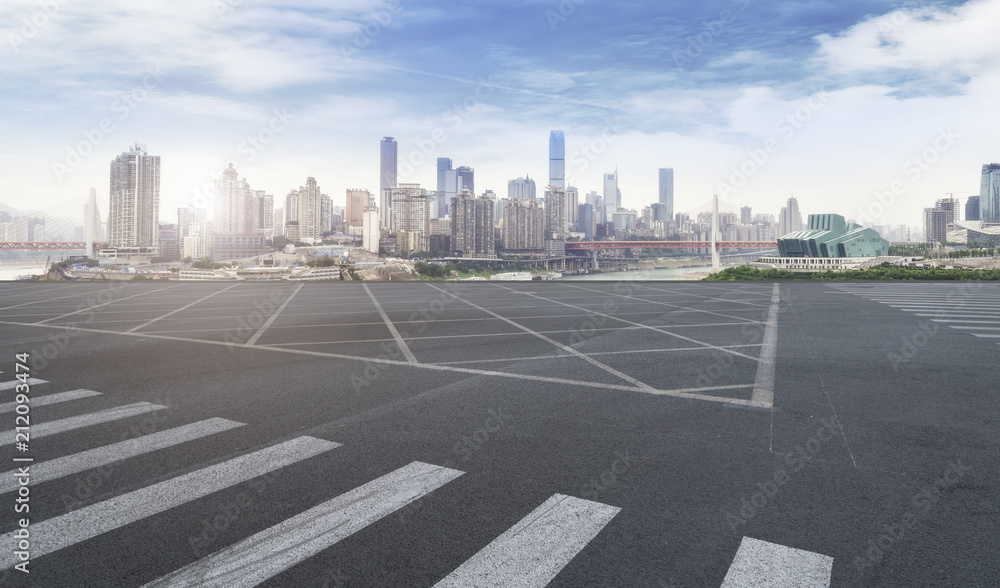 The empty asphalt road is built along modern commercial buildings in Chinas cities.