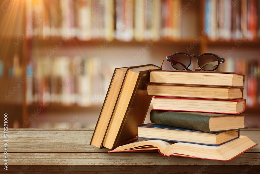 Composite image of eyeglasses on stack of books