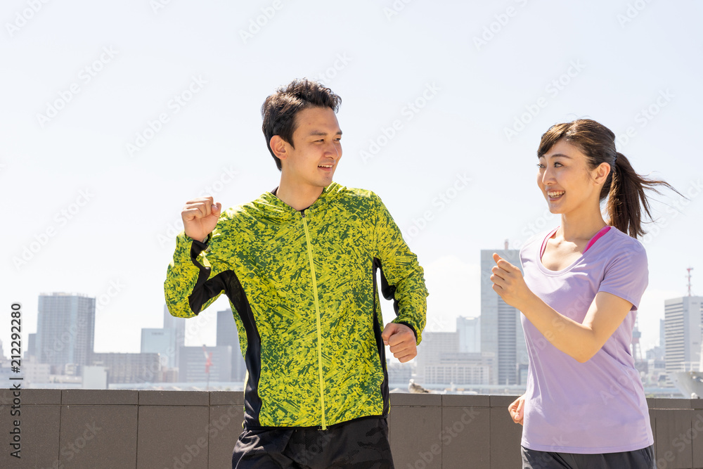 young asian couple running