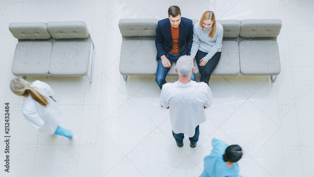 High Angle Shot in the Hospital, Young Couple Sitting in the Lobby Waiting for Test Results Receive 