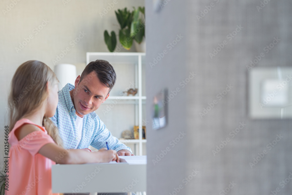 Young man and a little pupil doing homework