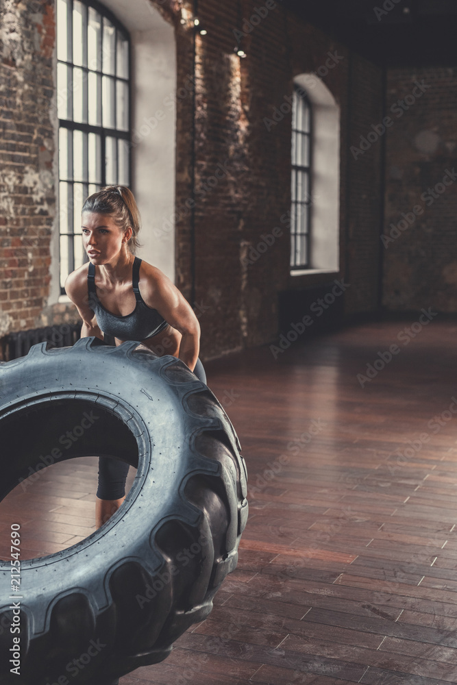 Athletic young woman with a wheel