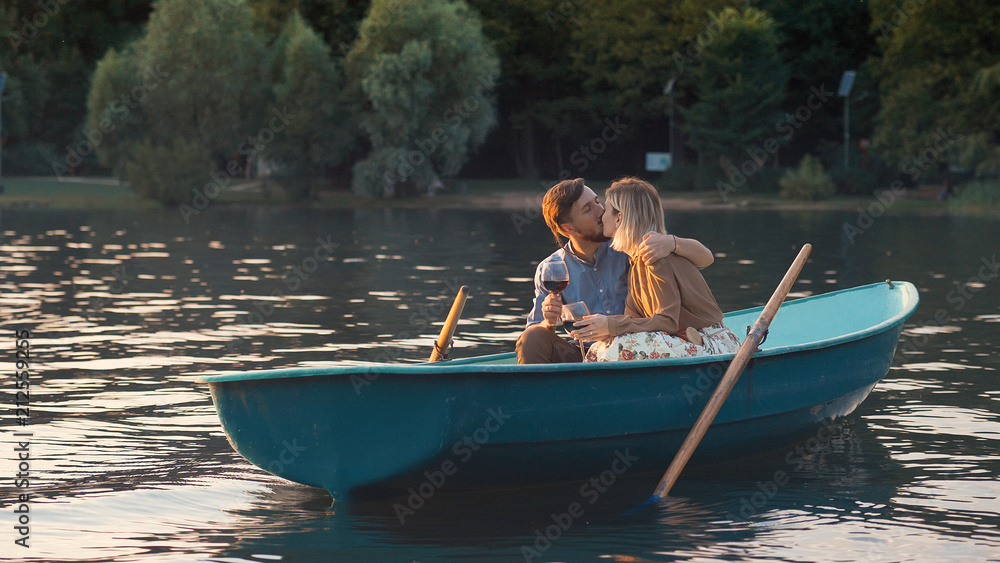 Kissing couple in a boat on a date