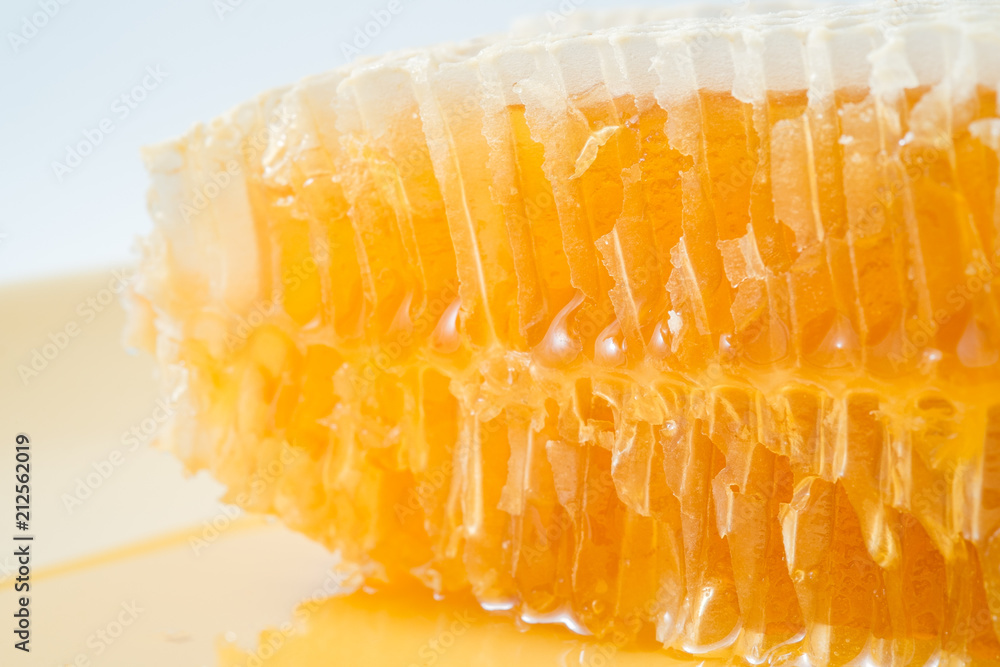 Bee honeycombs with honey closeup, a natural background