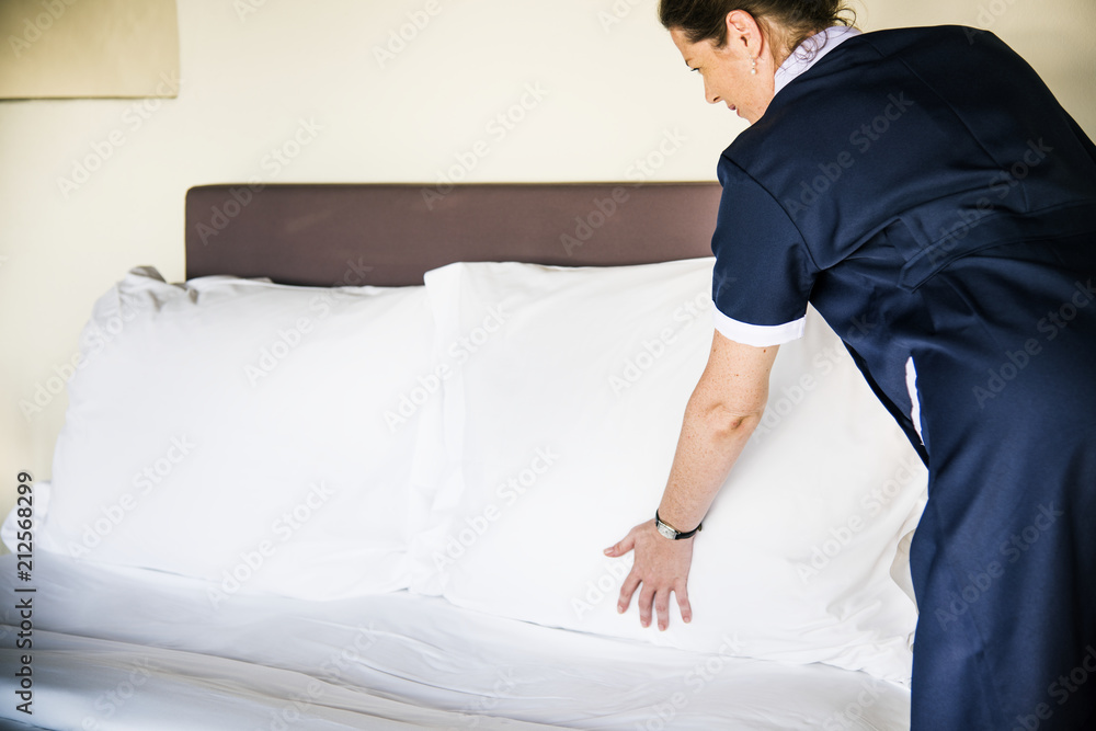 Housekeeper cleaning a hotel room