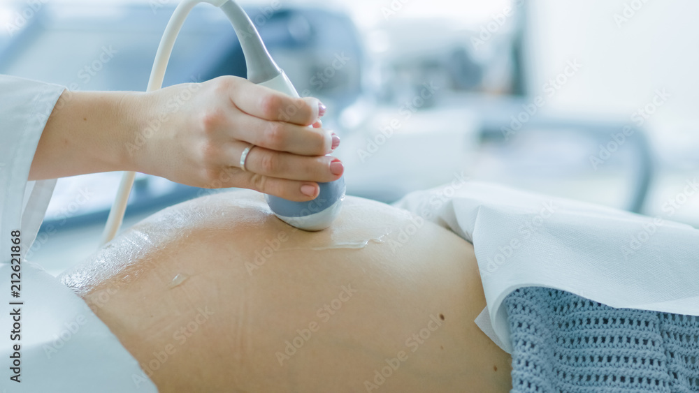 In the Hospital, Close-up Shot of the Doctor Doing Ultrasound / Sonogram Scan to a Pregnant Woman. O