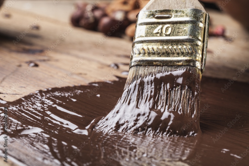 Painting a wood frame with chocolate color.