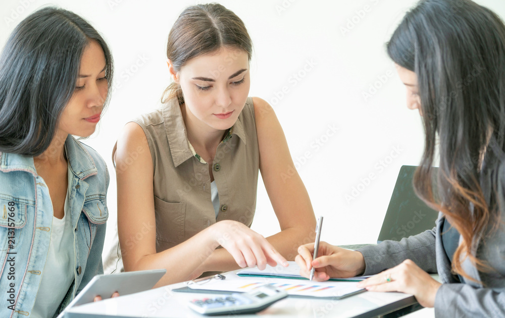 Multicultural businesswomen in group meeting.